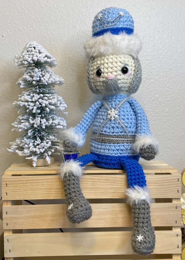 a crocheted nutcracker wearing boots