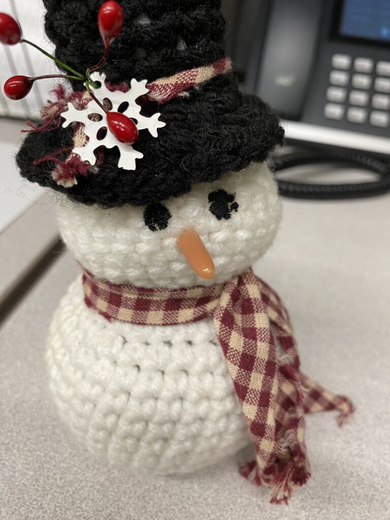 crocheted snowman amigurumi with large holes. Find out how to fix them