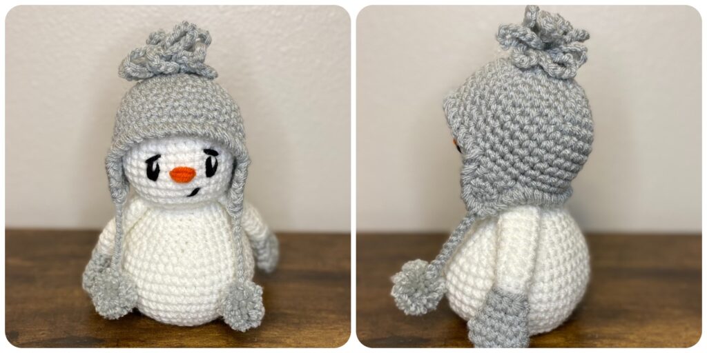 a crocheted snowman wearing a beanie