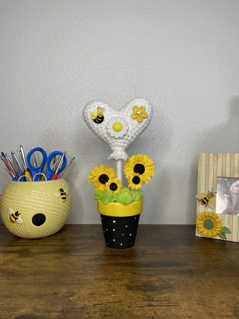 crocheted heart topiary with bee and flowers