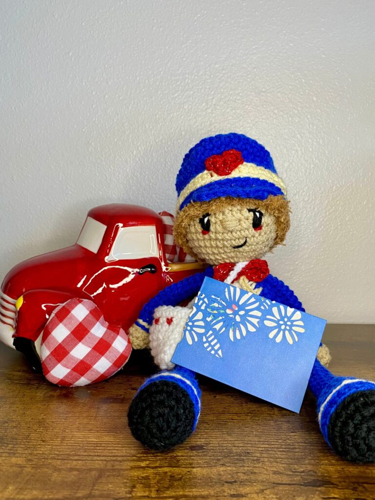 valentine boy with postman hat and bag. a crochet pattern