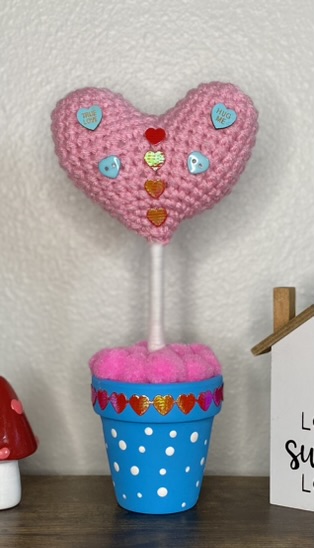 crocheted heart on a stick