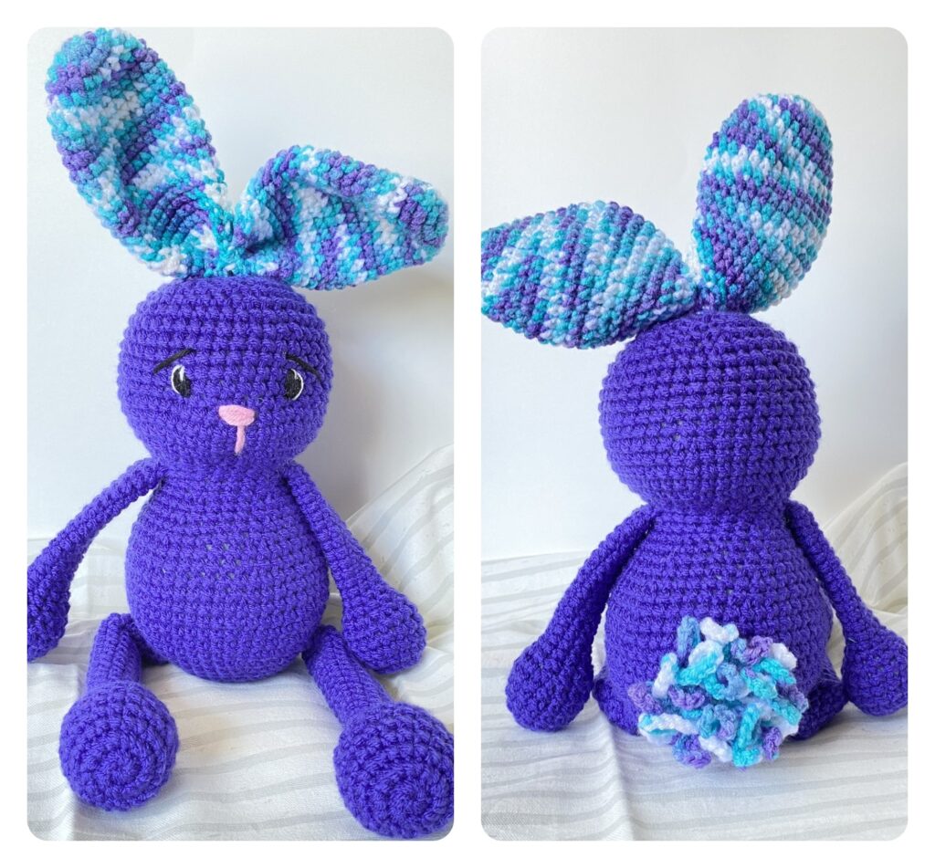 crocheted bunny with floppy ears and a loopy tail. a crocheted bunny with embroidered eyes and nose. Bunny amigurumi