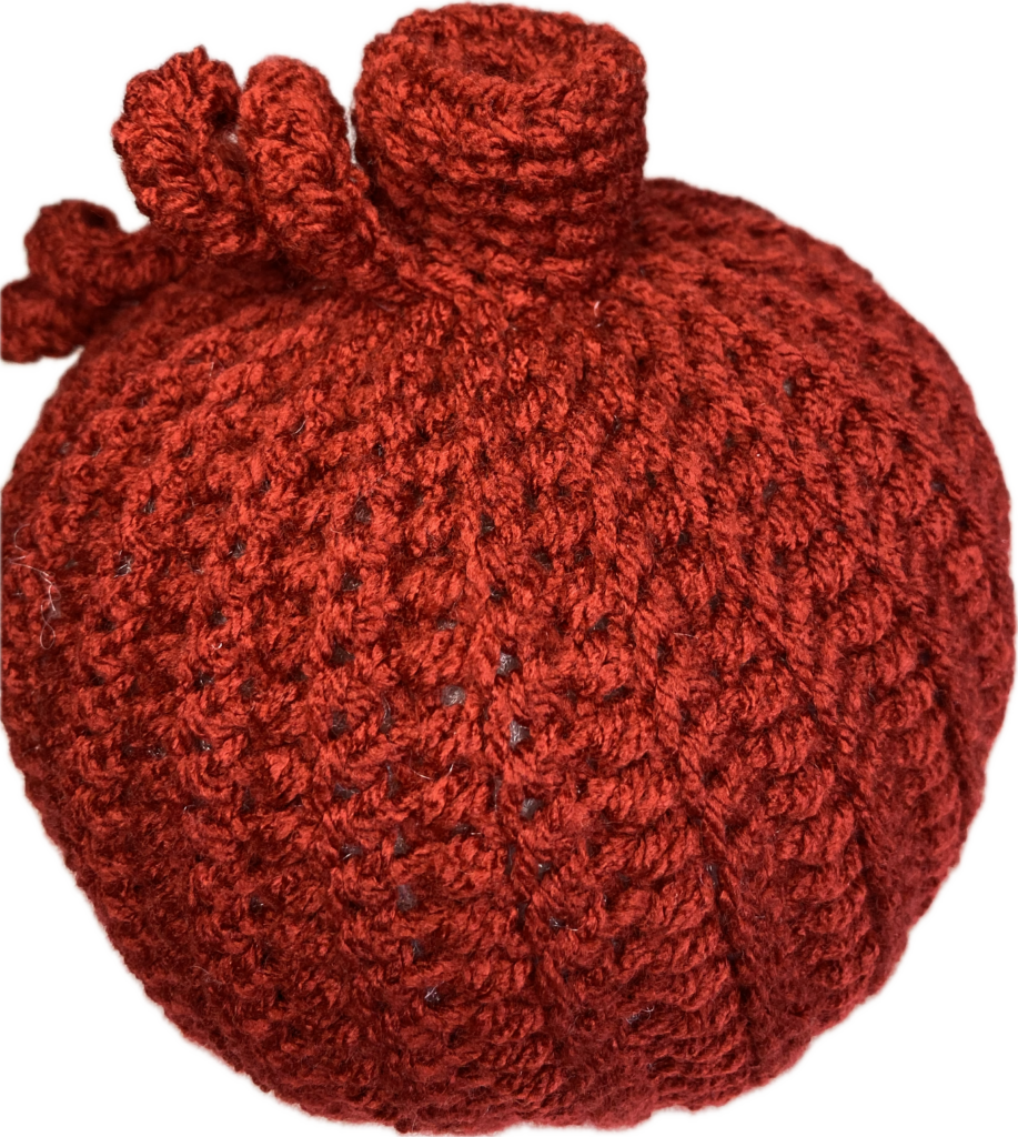 a red crocheted pumpkin